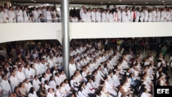 Cientos de médicos extranjeros escuchan a la presidenta brasileña, Dilma Rousseff, hablar de la contratación de doctores para el programa Mais Médicos.