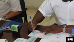 Un funcionario del Servicio Nacional de Migración de Panamá otorga permisos especiales de salida a migrantes cubanos.