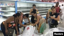 Cubanos compran pollo en un supermercado en La Habana.