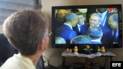 Una mujer mira en la TV cubana el encuentro entre Raúl Castro y Barack Obama en la VII Cumbre de las Américas.